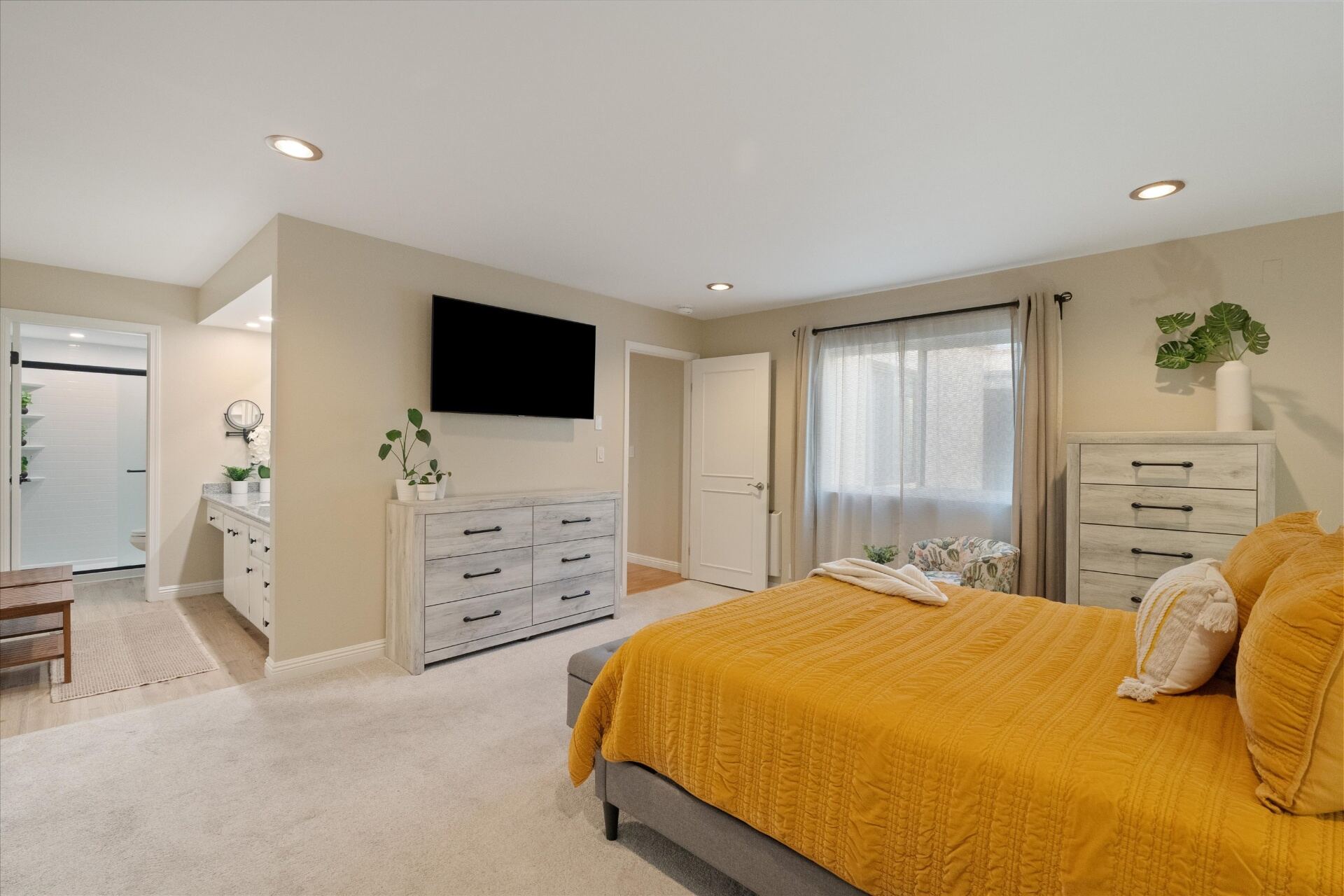Spacious primary bedroom with en-suite bath and natural light